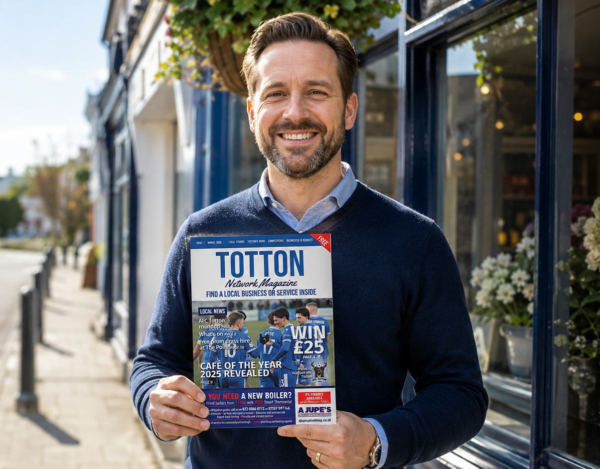 Local business owner holding a Network Magazine in Totton high street